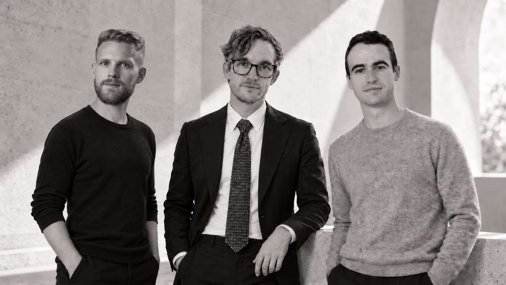 Flume's leadership team under a concrete arcade. From left: Casey Hancock, Chief Technology Officer; Will Coursen, Chief Deployment Officer; and Cédric Kovacs-Johnson, Founder and Chief Executive Officer.